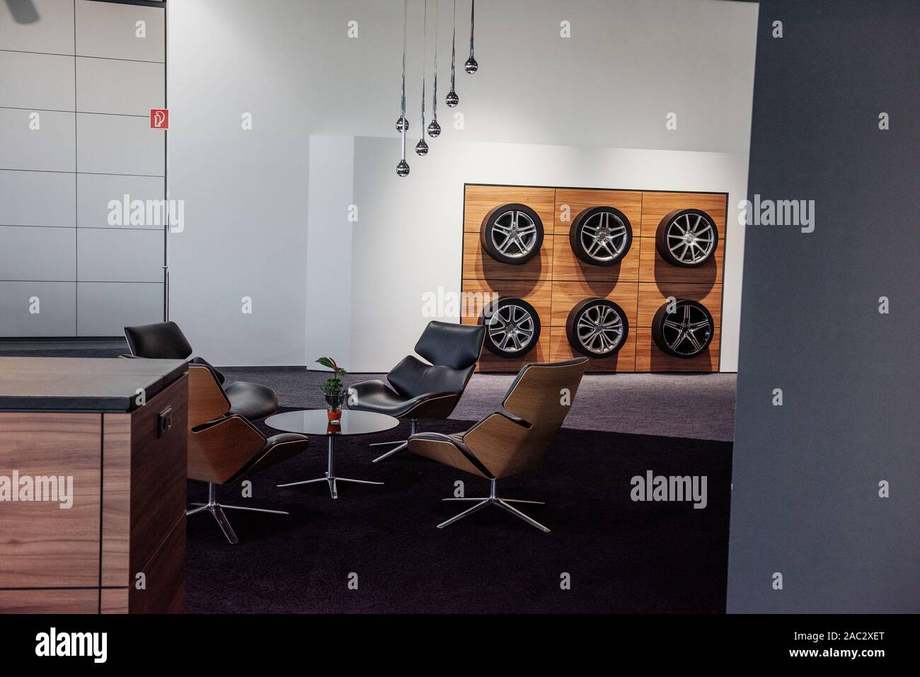 Interior of the car dealership with decorative wheels on the wall and