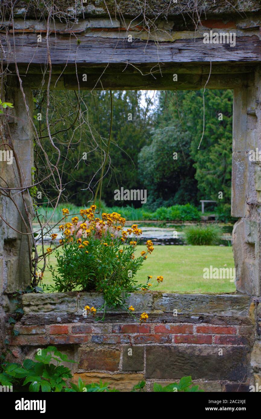 Garden ornaments. Window with flower in an English garden. Stock Photo