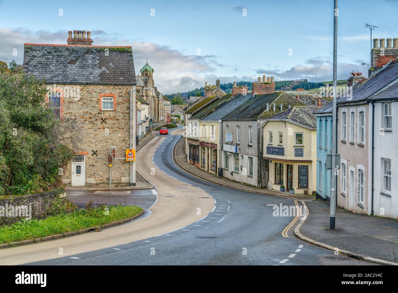 A colourful and quaint landscape of Lostwithiel Town, Cornwall, England, showing the main A390 road that passes through the shops and businesses. Stock Photo