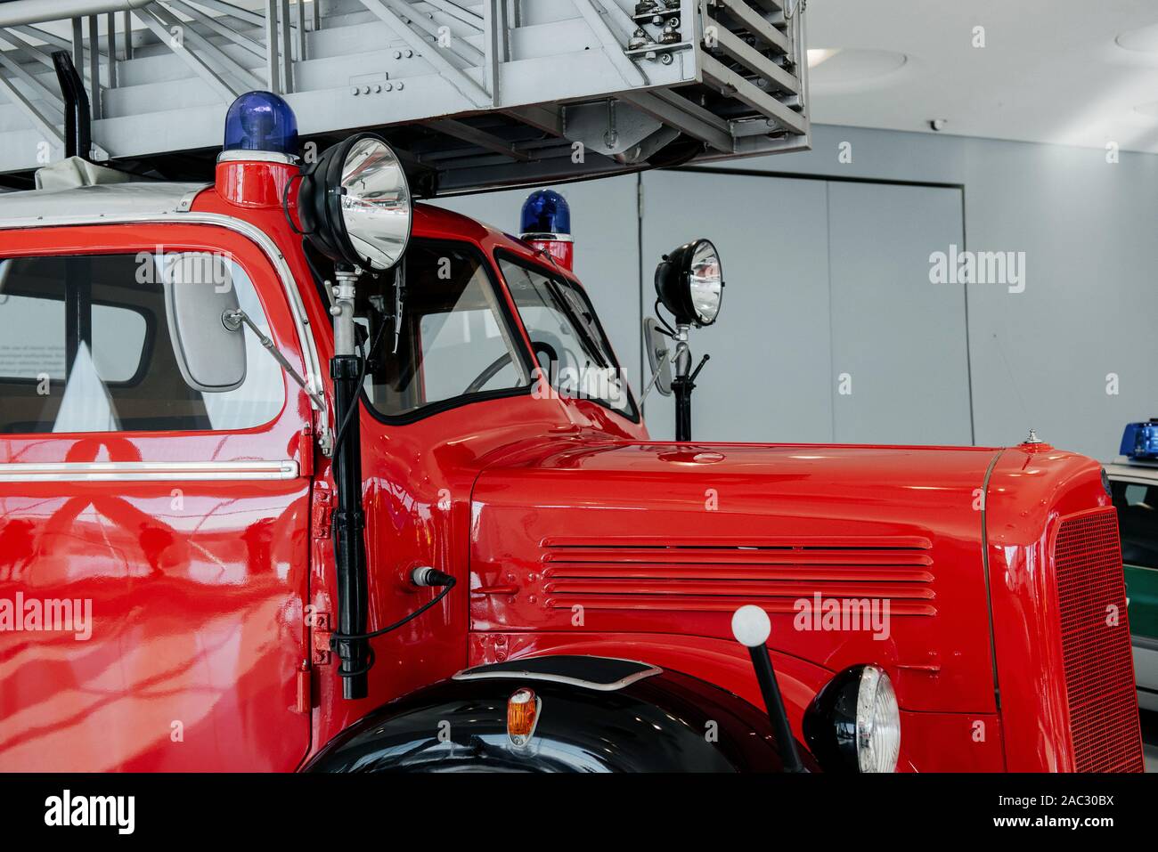 Side view. Front of the red polished fire truck standing indoor at ...