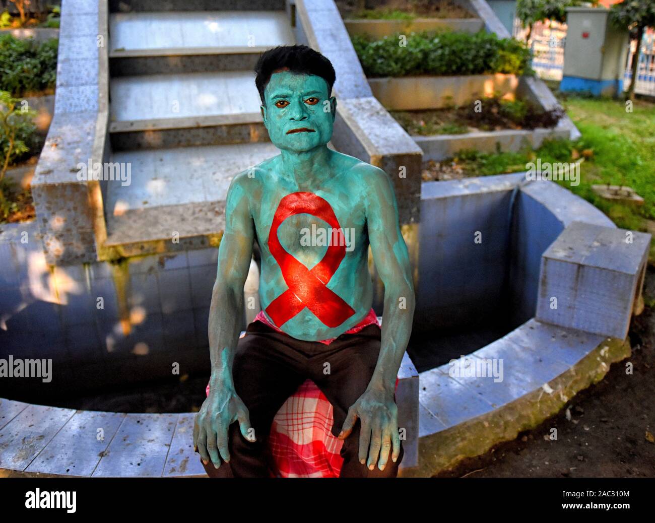 A man with a red ribbon painting on his body during the World AIDS Day ...