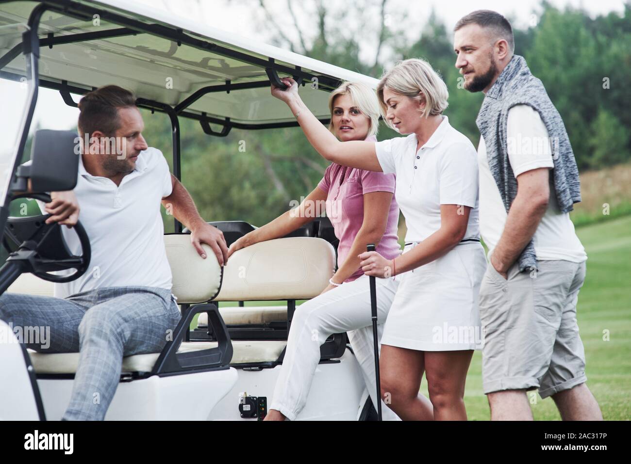Let's take a ride. Sitting to the golf cart after the game Stock Photo