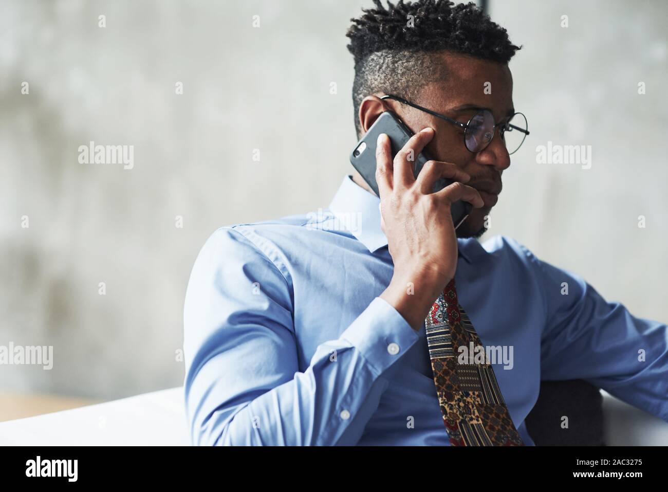 Close up photo of attractive stylish black businessman in suit talking ...