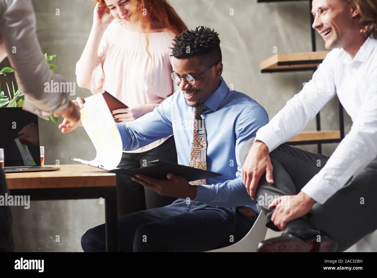 Work with documents and reports. Office workers having conversation during their job Stock Photo