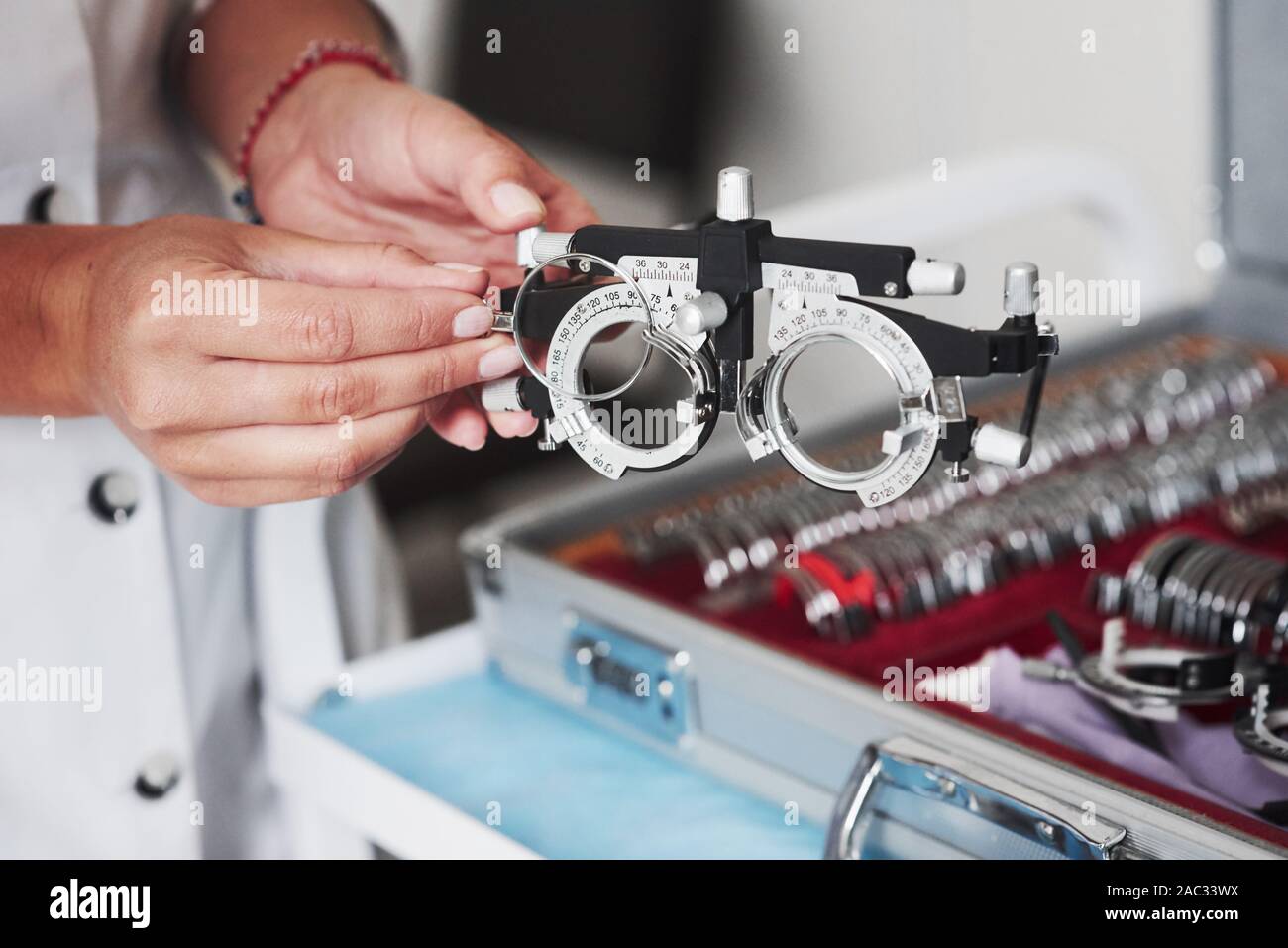 Changing the lenses. Female hands holding the optical device for eye testing Stock Photo Alamy
