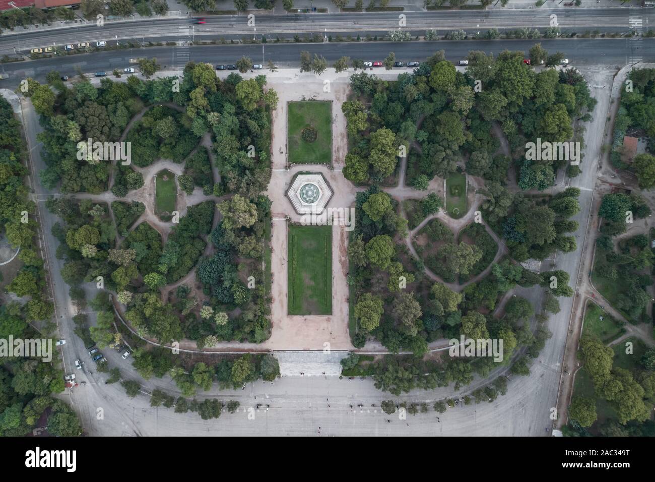 Aerial overhead drone shot of fountain in national garden in front of Zappeion Hall convention center in Athens Stock Photo