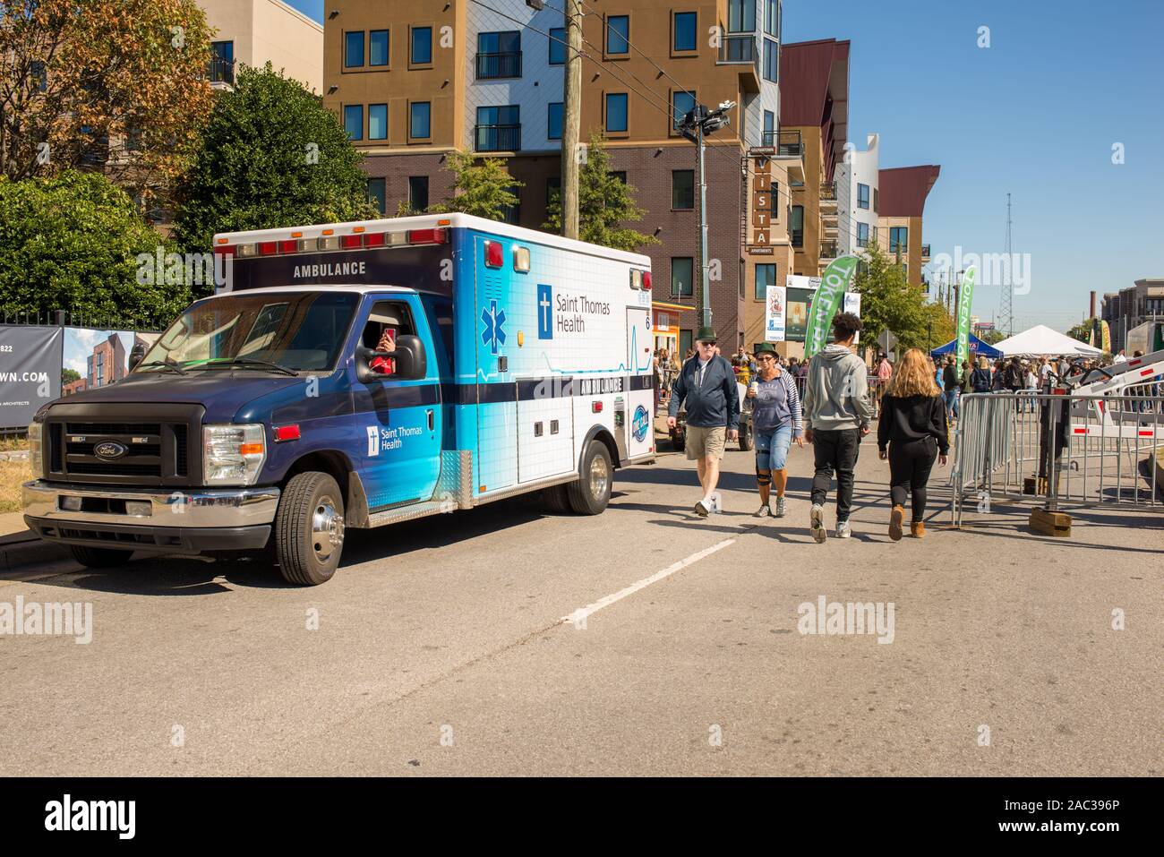 An ambulance waits close at-hand to ensure public safety at a community street party. Stock Photo