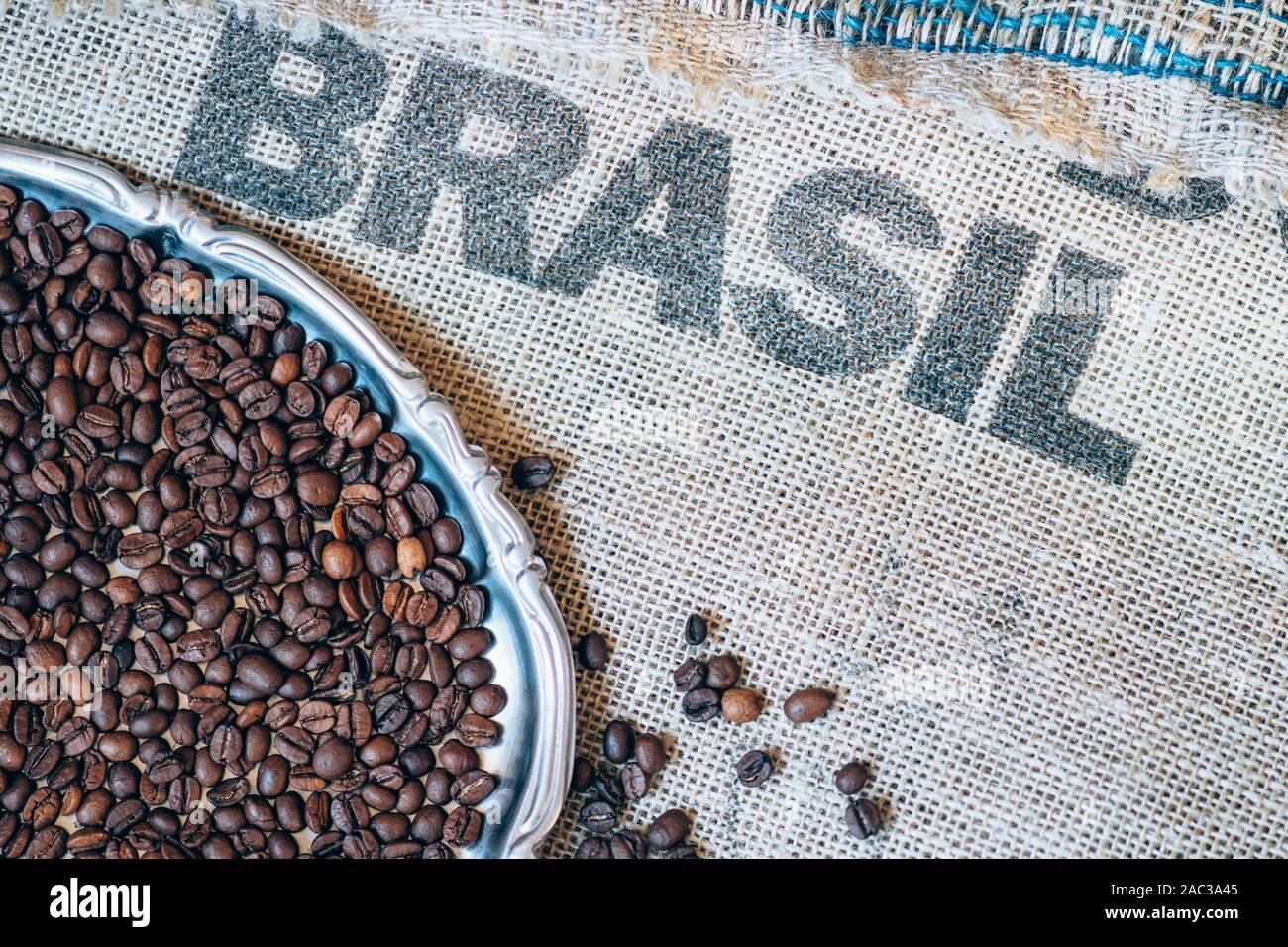 coffee beans on jute sack and printed Brasil on background Stock Photo