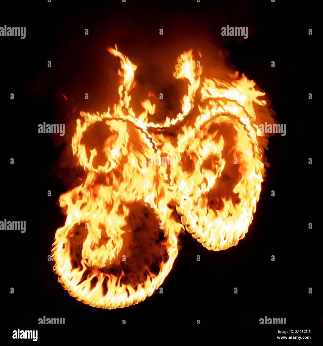 Om sign in flame and fire at black background Stock Photo