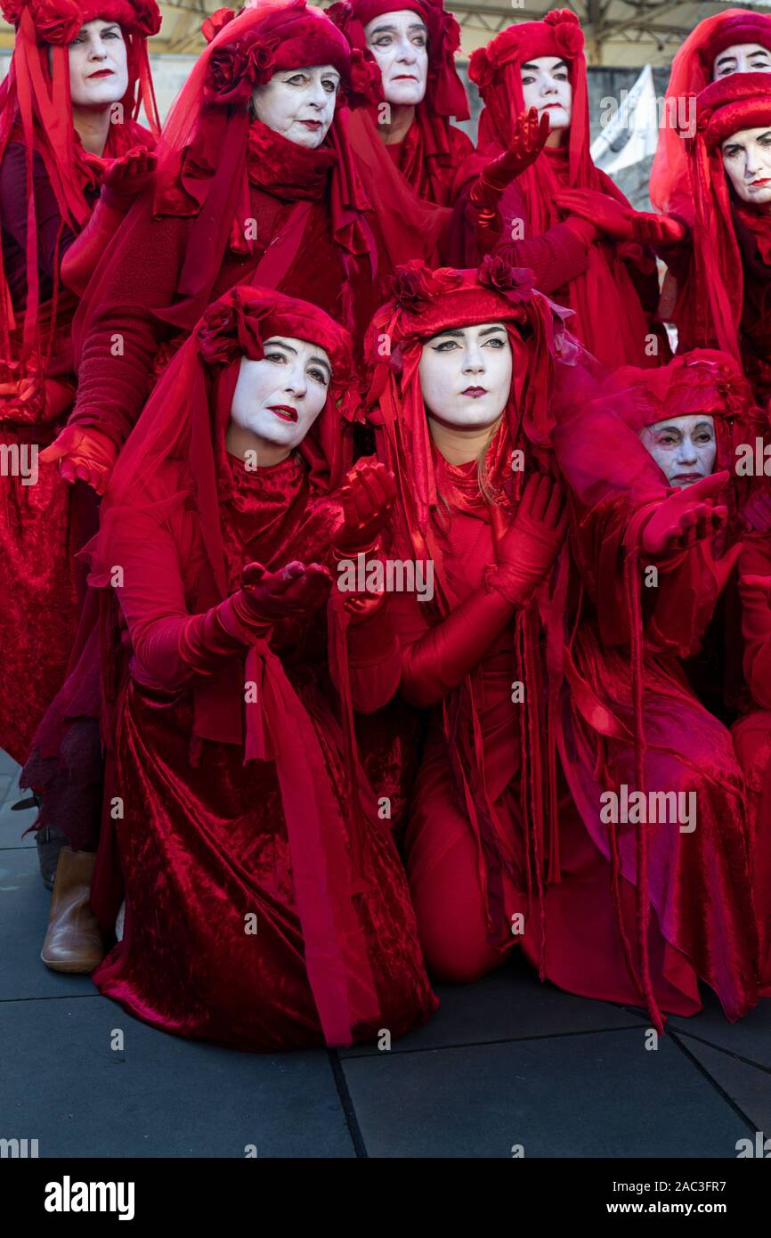 Extinction Rebellion Red Brigade climate change protesters march through Bath City centre with Bath Youth Climate Alliance campaigning for action. UK Stock Photo