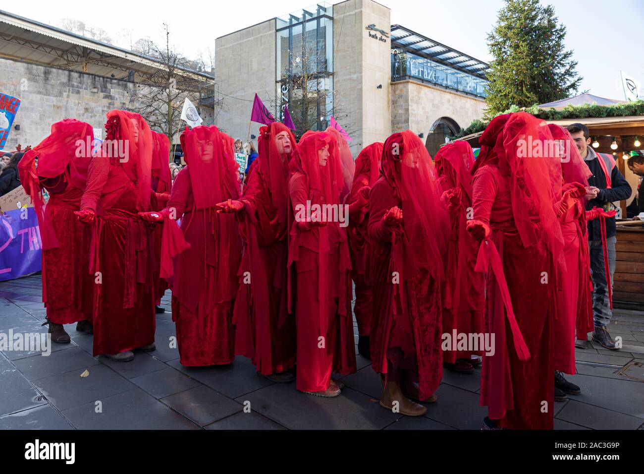 Extinction Rebellion Red Brigade climate change protesters march through Bath City centre with Bath Youth Climate Alliance campaigning for action. UK Stock Photo