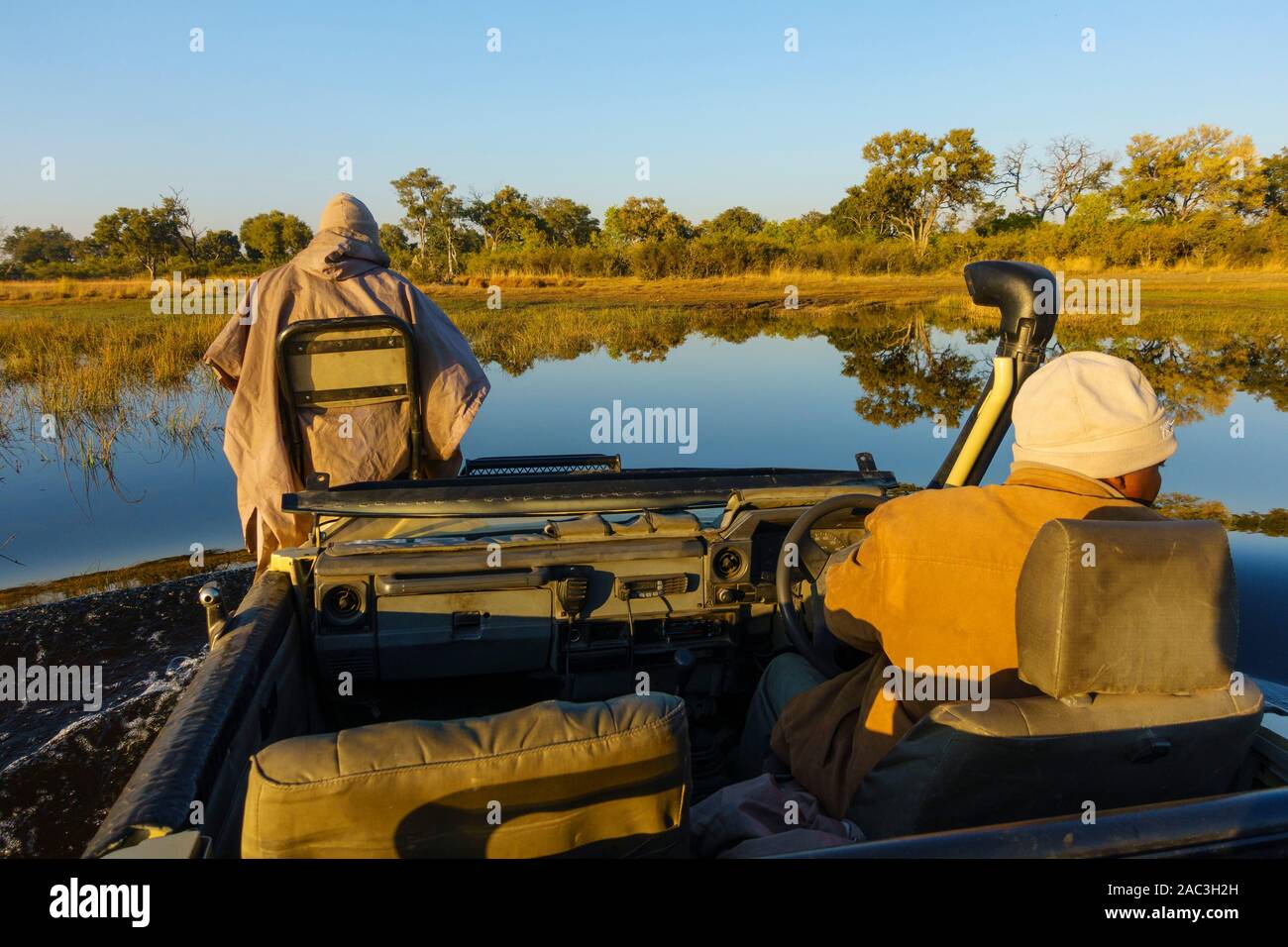 Open topped vehicle safari with driver and guide, Bushman Plains, Okavanago Delta, Botswana Stock Photo