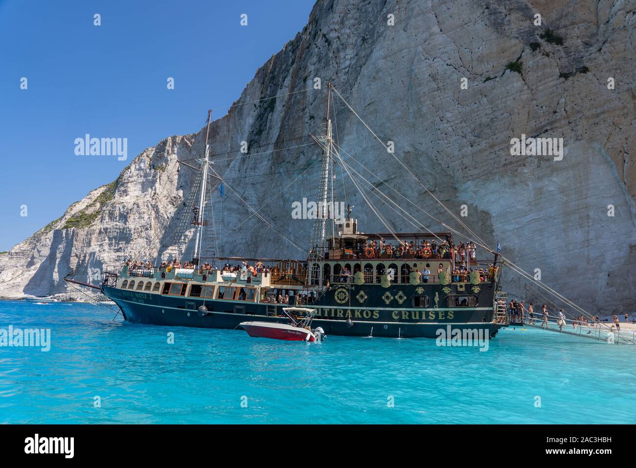 Zakynthos, Greece - August 20, 2019: Pirate ship style cruise ship full of tourists halt Zakynthos shipwreck Navagio bay Stock Photo
