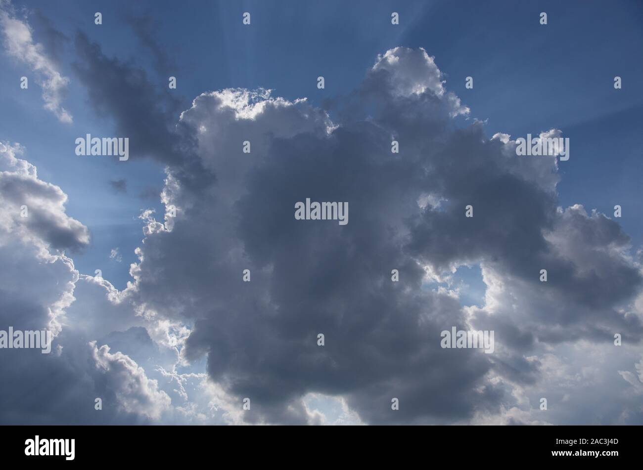 Cumulus clouds lit by the sun Stock Photo