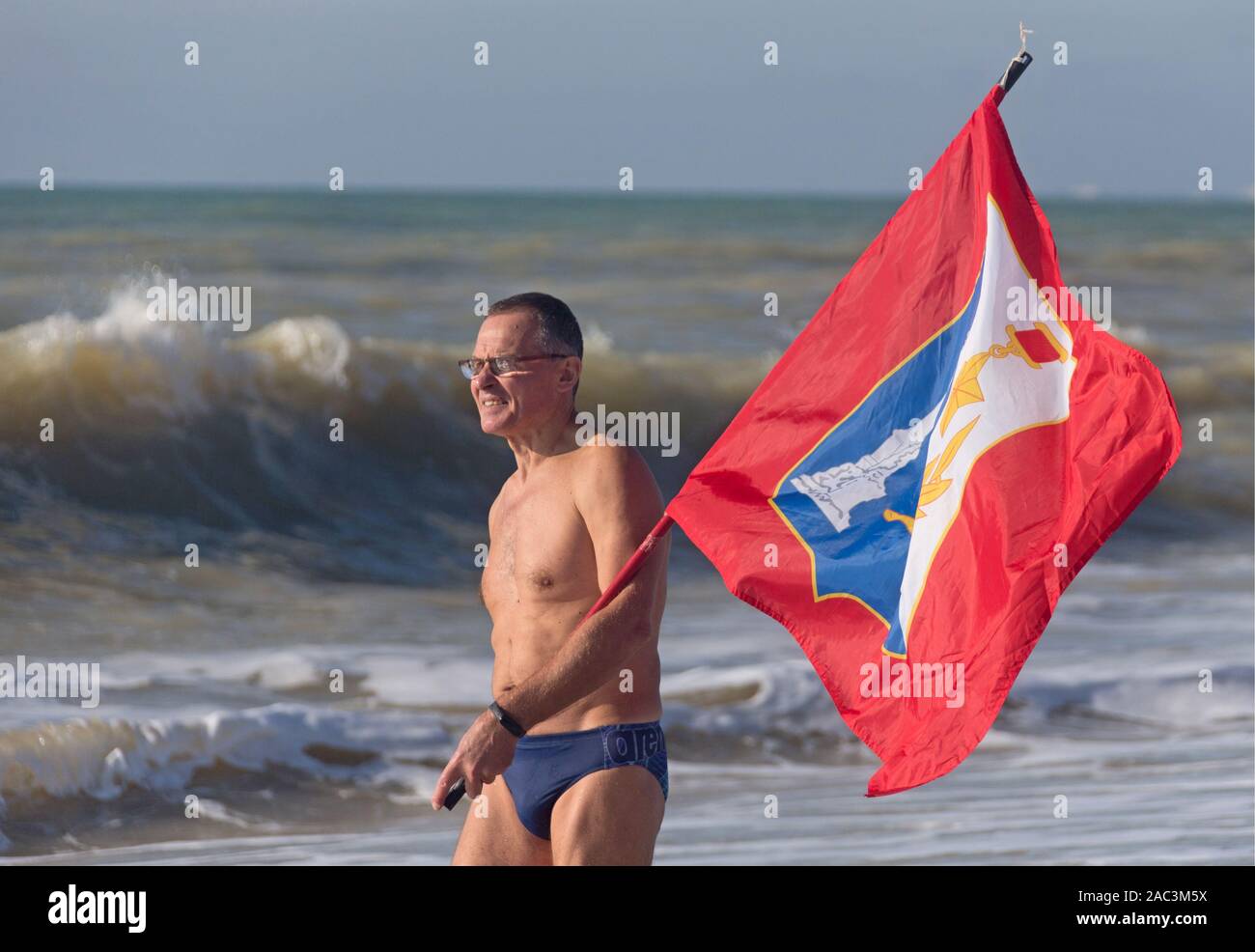 Saki, Russia. 30th Nov, 2019. CRIMEA, RUSSIA - NOVEMBER 30, 2019: A man  with a flag at