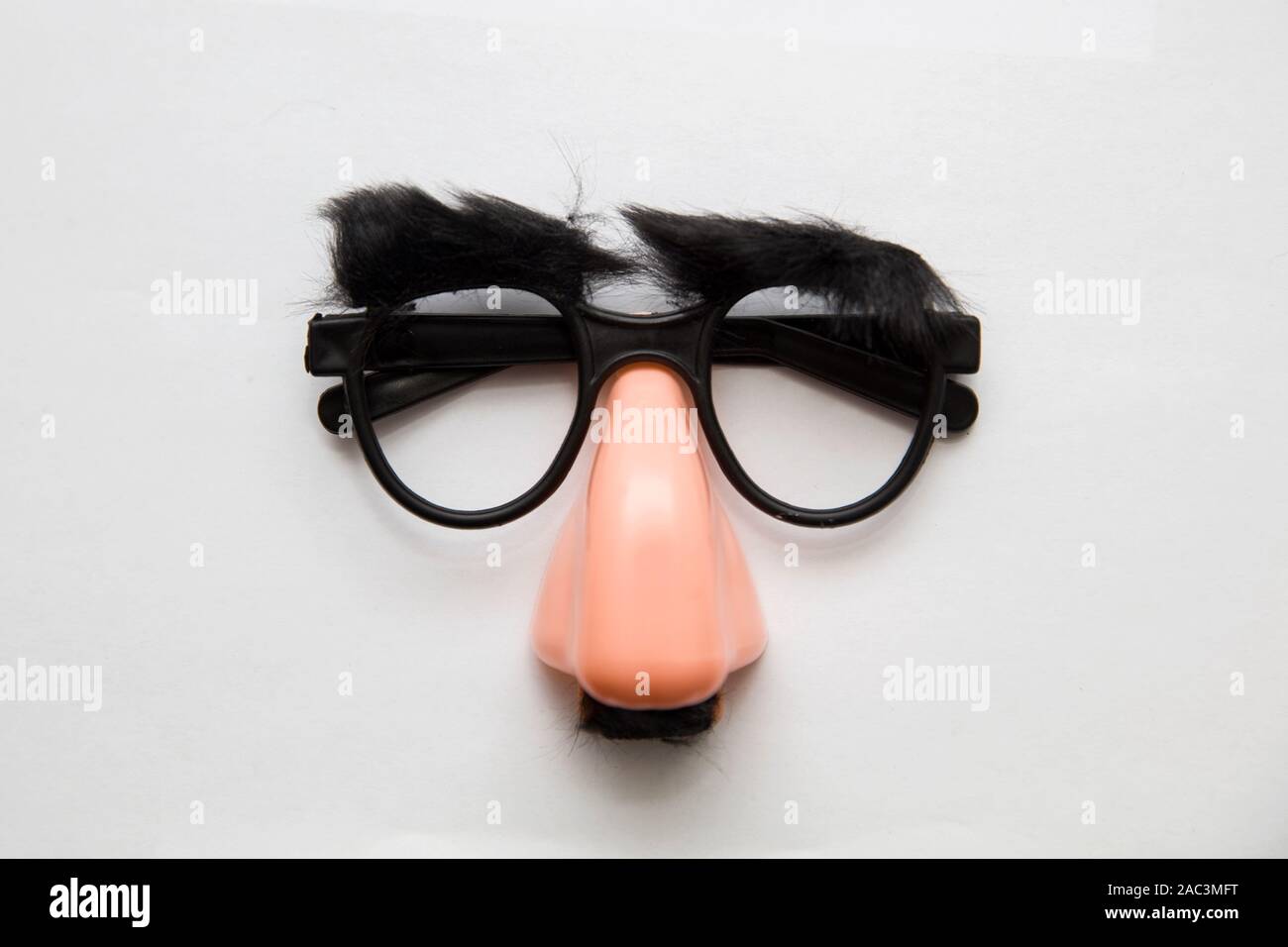 Closeup of a fake nose and glasses, with furry eyebrows, isolated on the  white background Stock Photo - Alamy