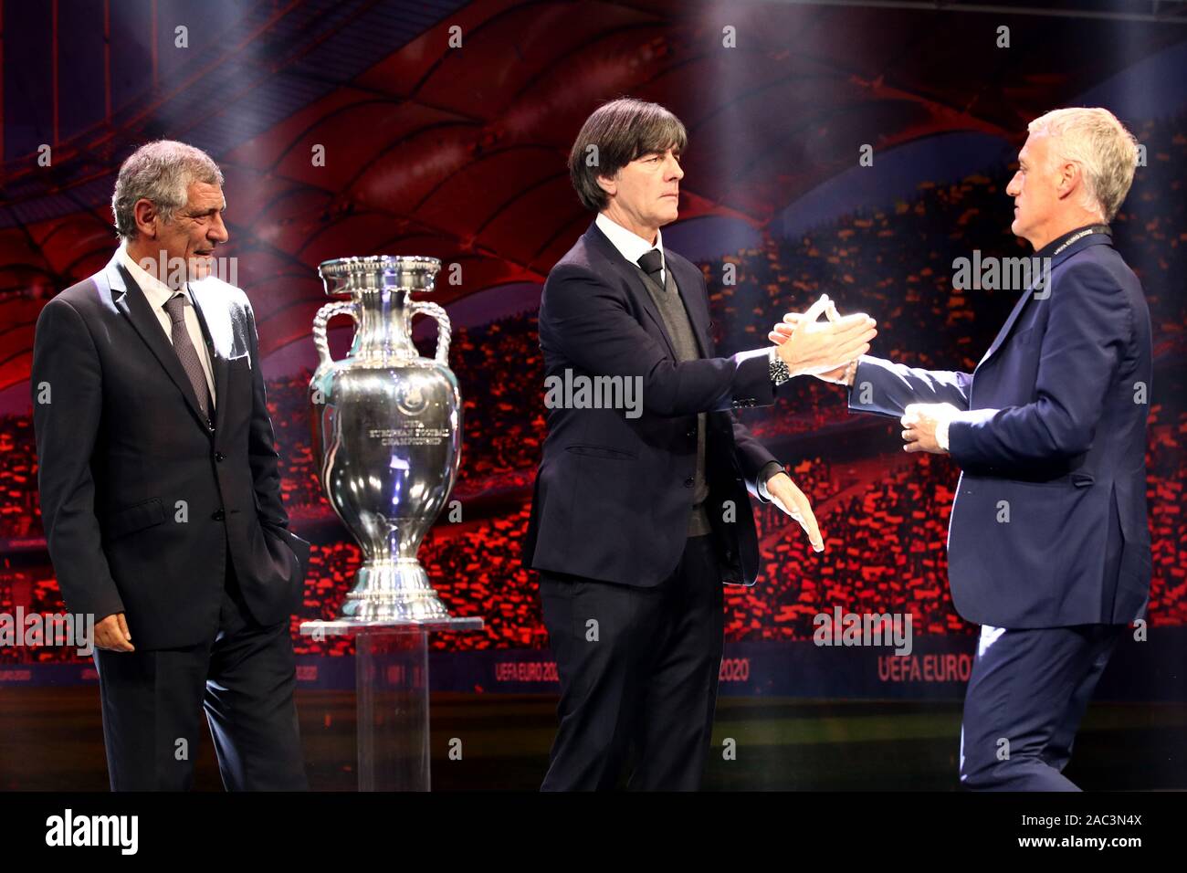 Bukarest, Romania. 30th Nov, 2019. Football, group draw for the European Football Championship 2020 at the Romexpo Exhibition Centre. The coaches of the drawn teams of Group F (Group F) are next to the European Cup: Fernando Santos (l), national coach of Portugal, Didier Deschamps (r), national coach of France, and Joachim Löw (M), national coach of Germany. UEFA EURO 2020 will take place in twelve countries from 12 June to 12 July 2020. Credit: Christian Charisius/dpa/Alamy Live News Stock Photo