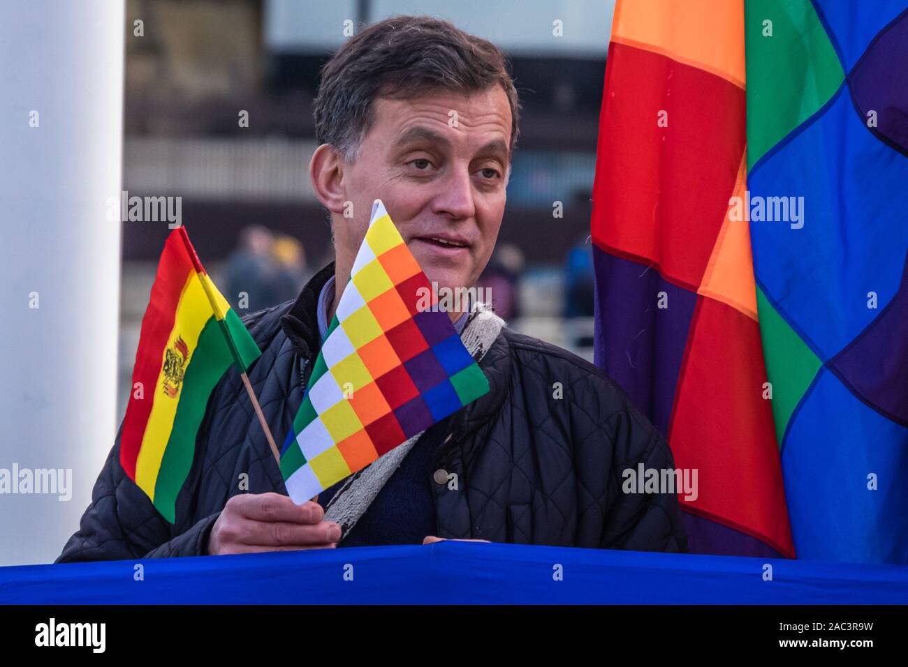 London, UK. 30th Nov, 2019. Protesters in Parliament Square denounce the right-wing coup against the democratically elected government of Evo Morales in Bolivia, supported by the US and backed by the UK and western media. The military and interim government have issued arrest warrants for Morales and opposition leaders and launched a racist campaign of terror, burning the Wiphala indigenous flag, killing over 30 protesters and injuring hundreds. The coup will let multinationals including Shell and BP exploit Bolivia's reserves of lithium and natural gas. Credit: Peter Marshall/Alamy Live News Stock Photo