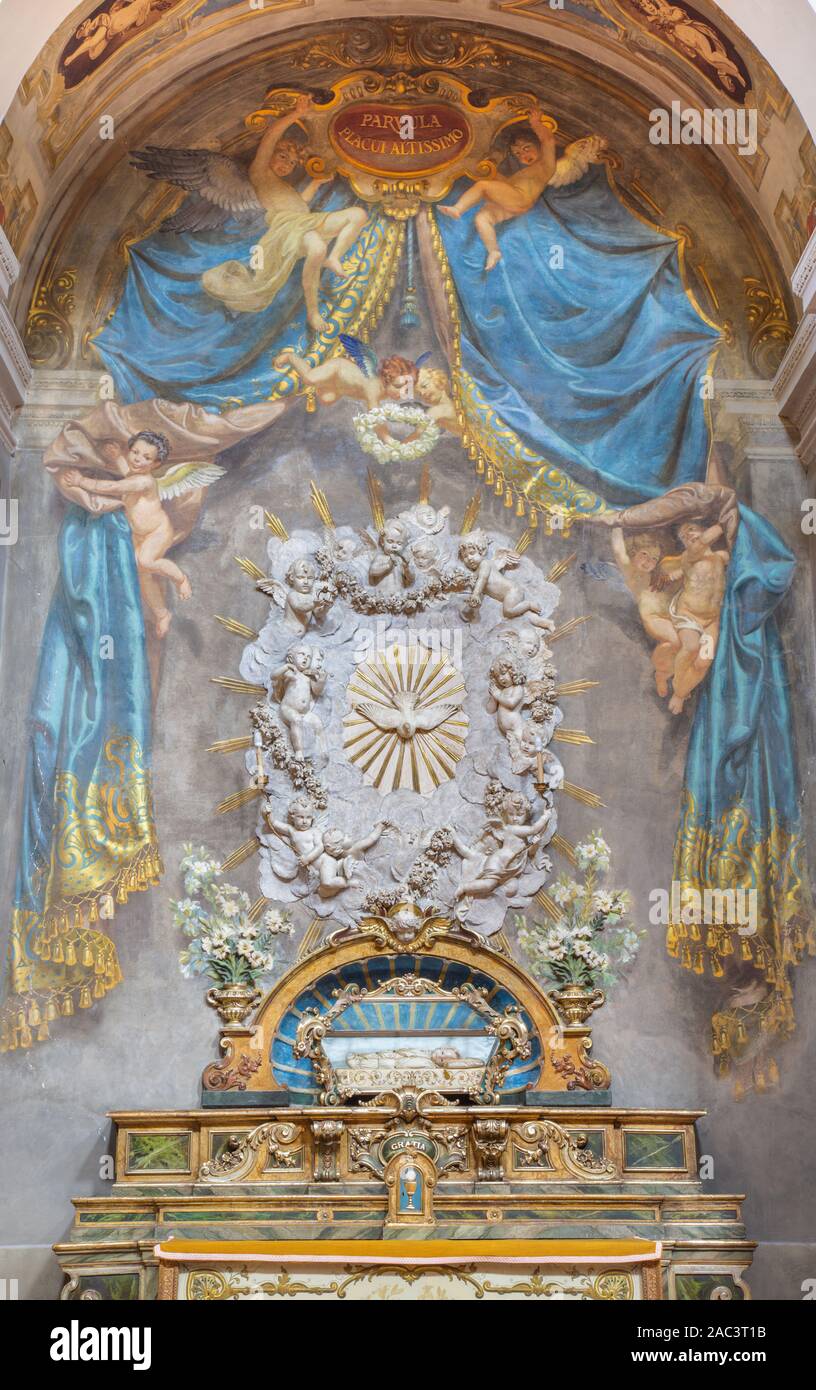 PARMA, ITALY - APRIL 17, 2018: The baroque altar relief with the Holy Spirit among the angels in church Chiesa di San Bartolomeo from 17. cent. Stock Photo