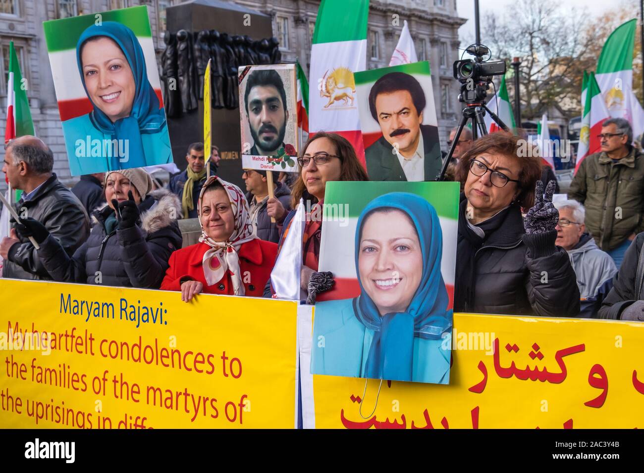 London, UK. 30th Nov, 2019. Anglo-Iranian Communities in the UK and supporters of the People's Mujahedin of Iran's National Council of Resistance of Iran rally at Downing St in support of protests in Iran against the clerical regime. Over 450 protesters have been killed in the brutal suppression of the Iran protests by security forces, with 4000 injured and thousands arrested. There were speeches and songs and a street theatre re-eneactment of the killings and but an attempt to deliver a letter to the Prime Minister was refused entry. Credit: Peter Marshall/Alamy Live News Stock Photo