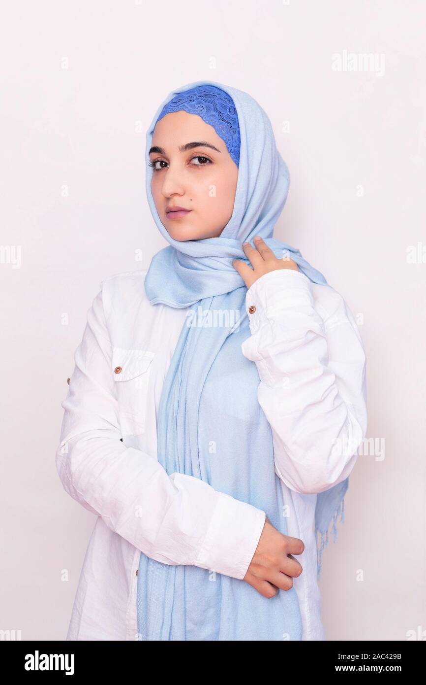 Elegant Muslim woman in a white shirt and bright blue hijab. Stylish Iranian girl in Muslim clothing. Isolated portrait Stock Photo - Alamy Elegant Muslim woman in a white shirt and bright blue hijab. Stylish Iranian girl in Muslim clothing. Isolated portrait Stock Photo - Alamy