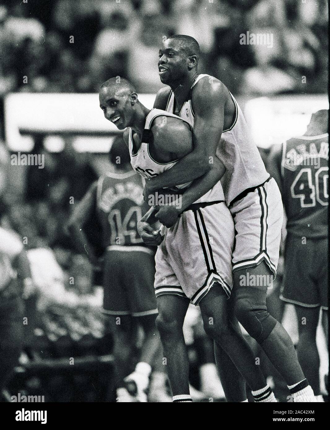 Boston Celtics Ed Pinckney (right) hugs teamate Dee Brown during basketball game action against the Washington Bullets at the Fleet center in Boston Ma USA April 1 1994 photo by bill belknap Stock Photo