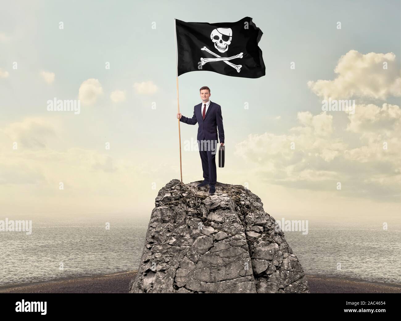 Successful businessman on the top of a mountain holding pirate flag ...