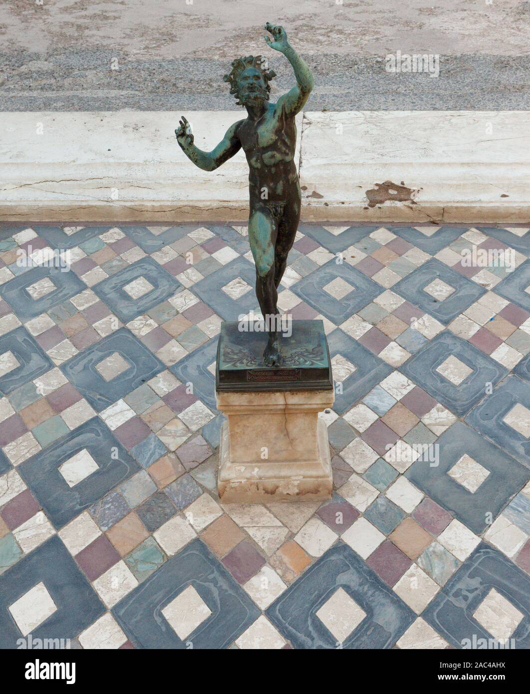 Dancing faun statue in the house of the faun of Pompeii (Pompei). Ancient Roman city in Pompei, Province of Naples, Campania, Italy Stock Photo