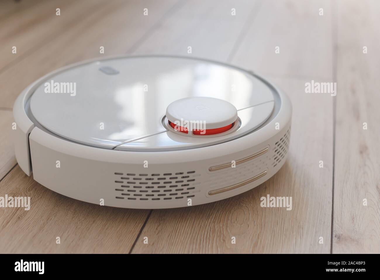 Home vacuum cleaning robot cleaning the room Stock Photo Alamy