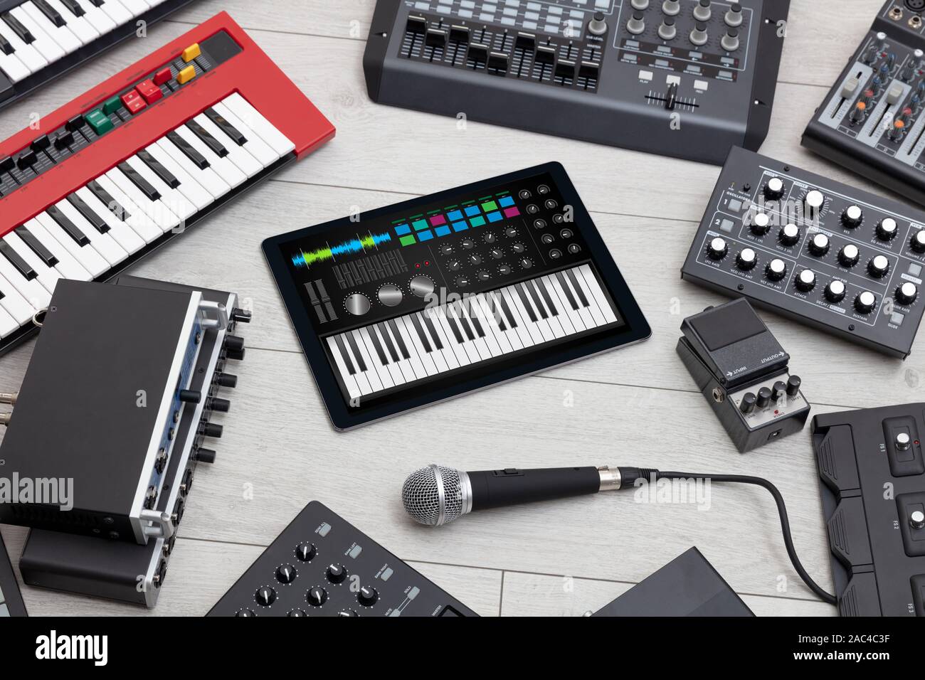 Piano synthesizer app on tablet and musical instrument concept Stock
