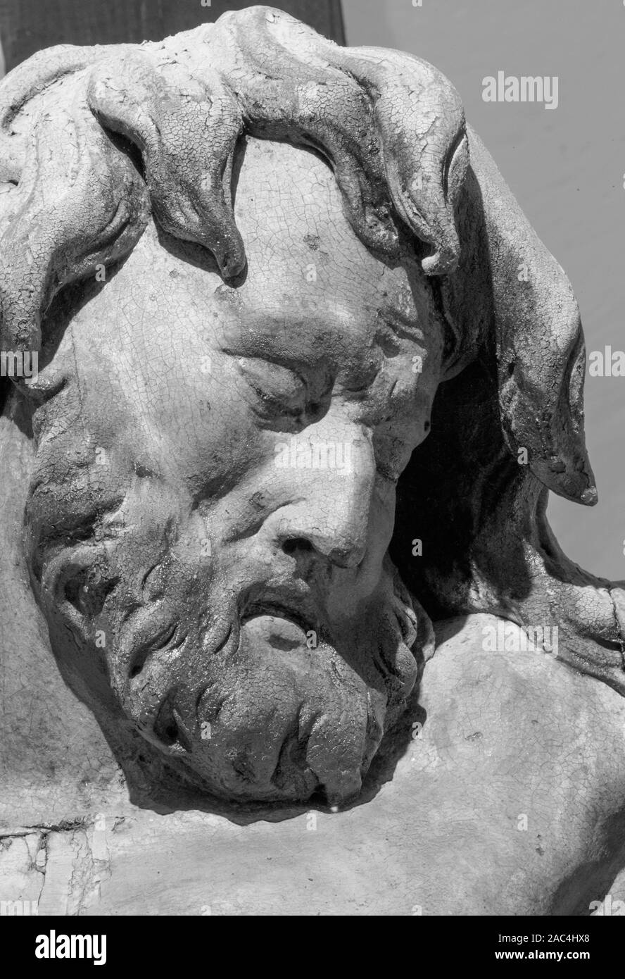 BANSKA STIAVNICA, SLOVAKIA - FEBRUARY 19, 2015: The face detail of carved statue of Impenitent thief as the part of baroque Calvary. Stock Photo