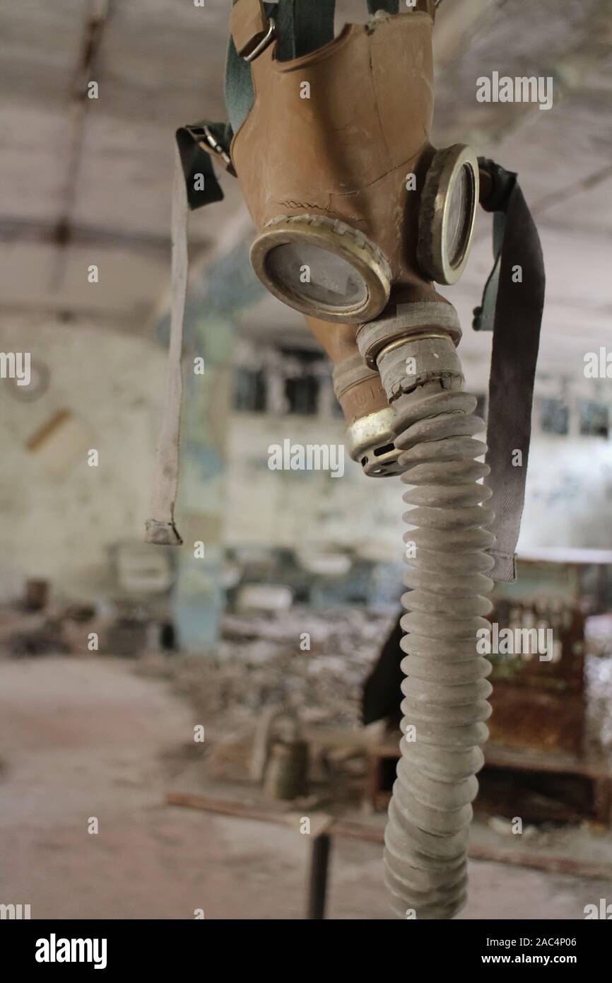 Hanging soviet gas mask in an abandoned building in Pripyat, Ukraine, site of the 1986 Chernobyl disaster and center of the Chernobyl exclusion zone. Stock Photo