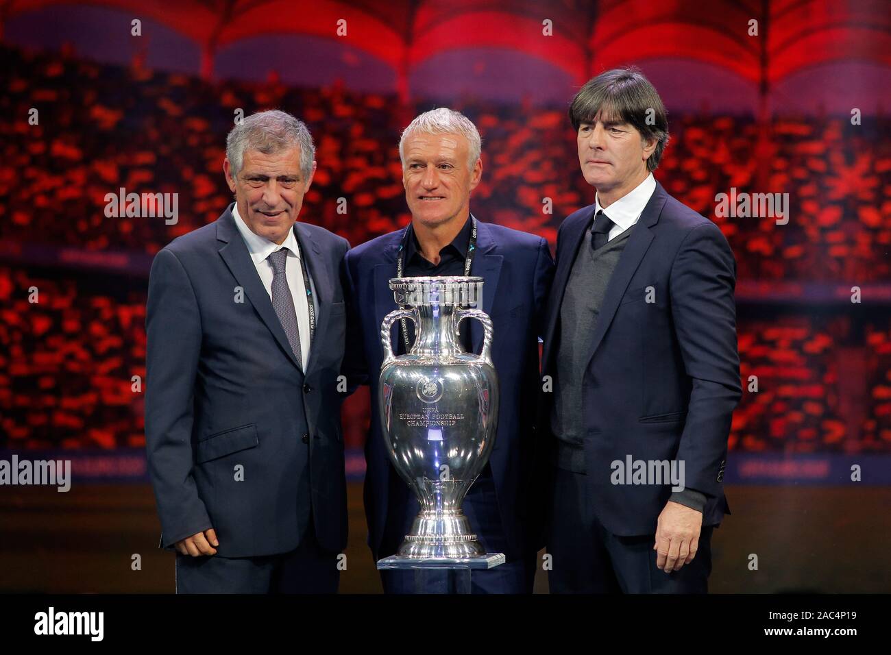 Bucharest, Romania. 30th Nov, 2019. (L-R) Head coach of Portugal Fernando Santos, head coach of France Dider Deschamp and head coach of Germany Joachim Loew pose with the trophy during the draw of the UEFA Euro 2020 soccer tournament finals in Bucharest, capital of Romania, Nov. 30, 2019. Credit: Cristian Cristel/Xinhua/Alamy Live News Stock Photo