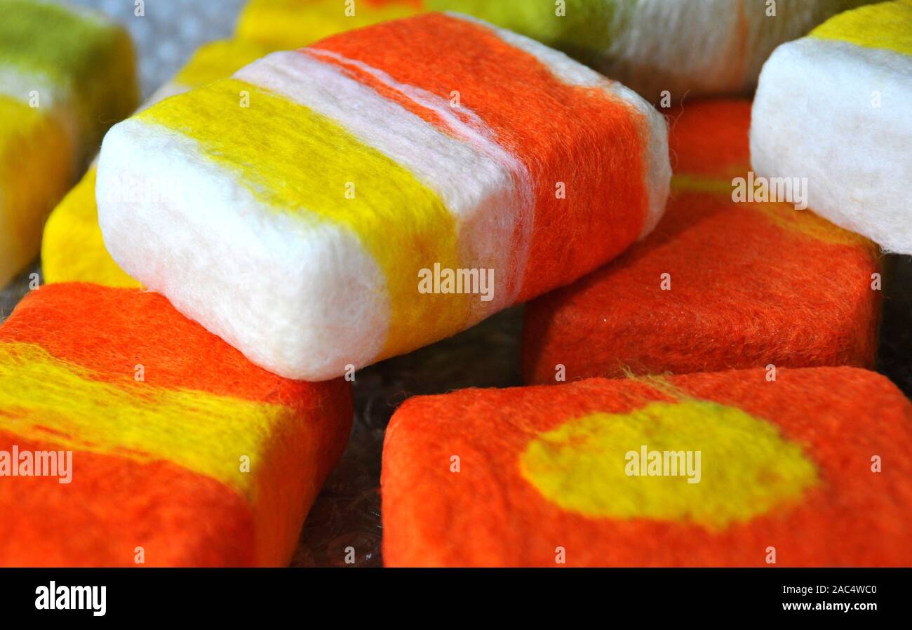 Bars of soap being covered with felt in a wet felting process Stock Photo