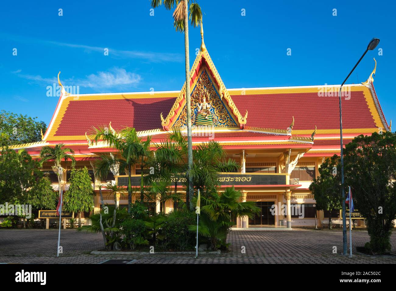 Wat Phra Thong Museum with a frieze of a sitting Buddha on the roof, in the grounds of Wat Phra Thong (temple) in Thalang, Phuket, Thailand Stock Photo