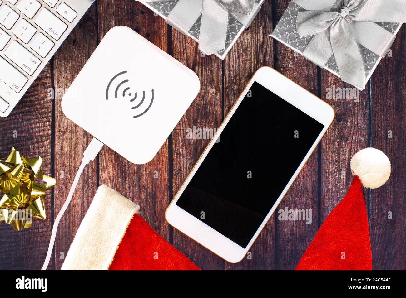 Electronics with Christmas holidays ornaments around Stock Photo