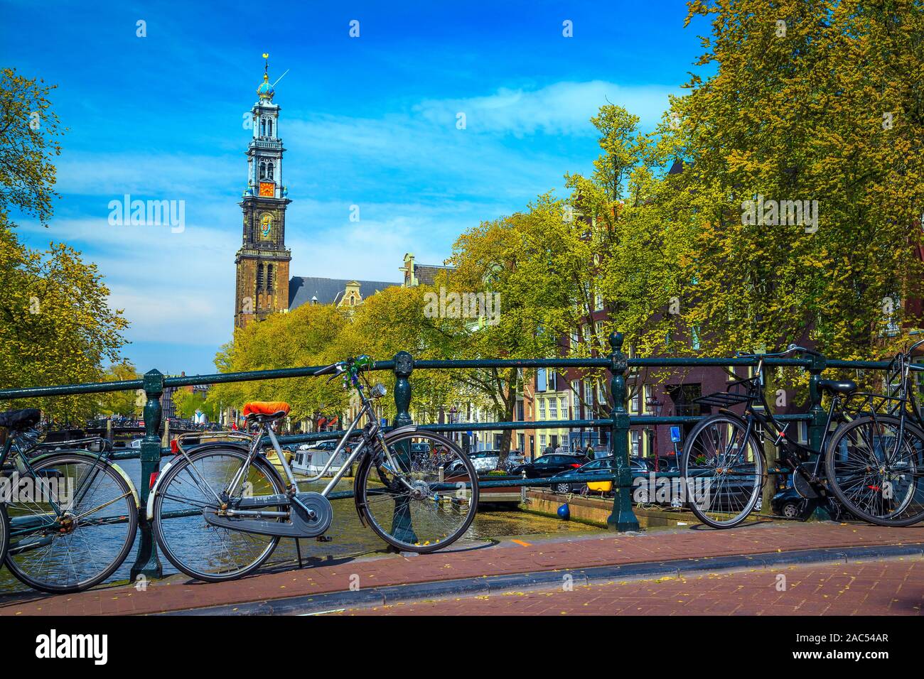 Popular travel and touristic destination in Netherlands. Bicycles on the bridge and spectacular water canals in Amsterdam, Netherlands, Europe Stock Photo