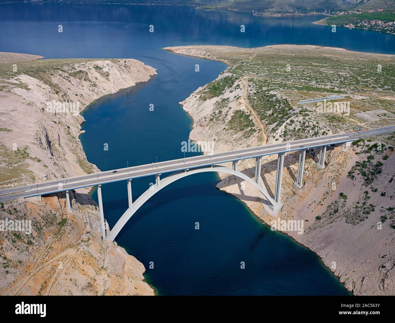 AERIAL VIEW. The Novsko Zdrilo Channel is spanned by another bridge, also named Maslenica Bridge. Dalmatia, Adriatic Sea, Croatia. Stock Photo