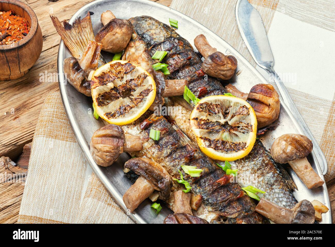Pechanga Fish Baked whole pelengas fish with mushrooms and lemon.Sea food.Grilled ...
