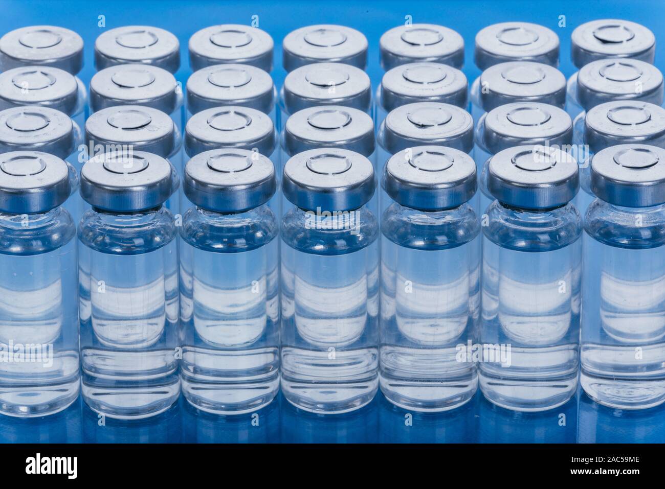 Glass medical ampoule vial for injection. Medicine is dry white drug