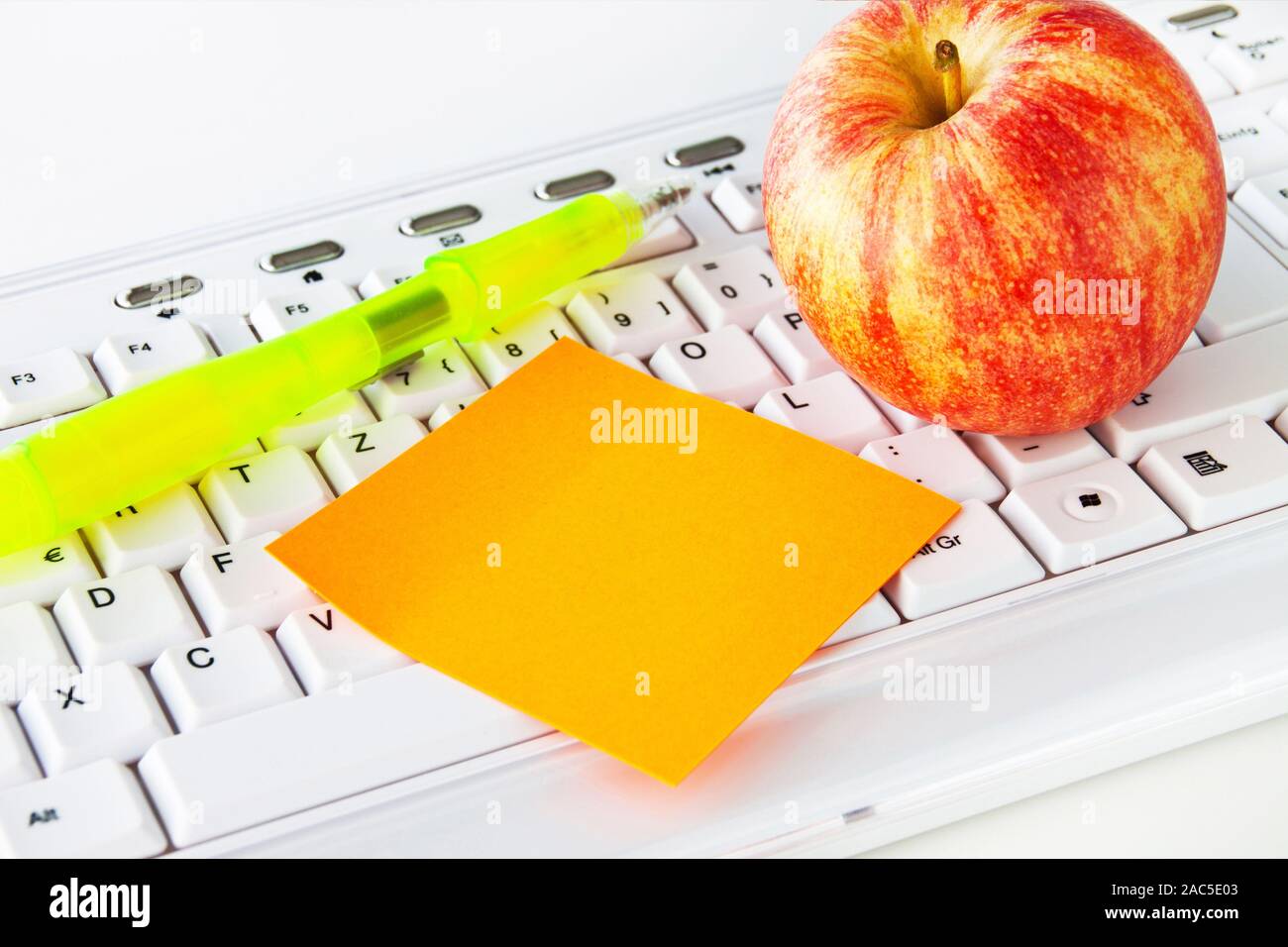 Keyboard and apple with notepad Stock Photo Alamy