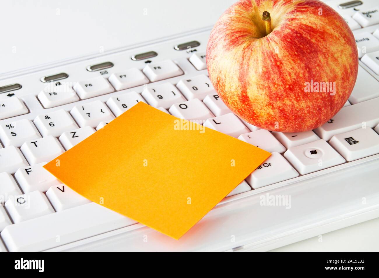 Keyboard and apple with notepad Stock Photo Alamy
