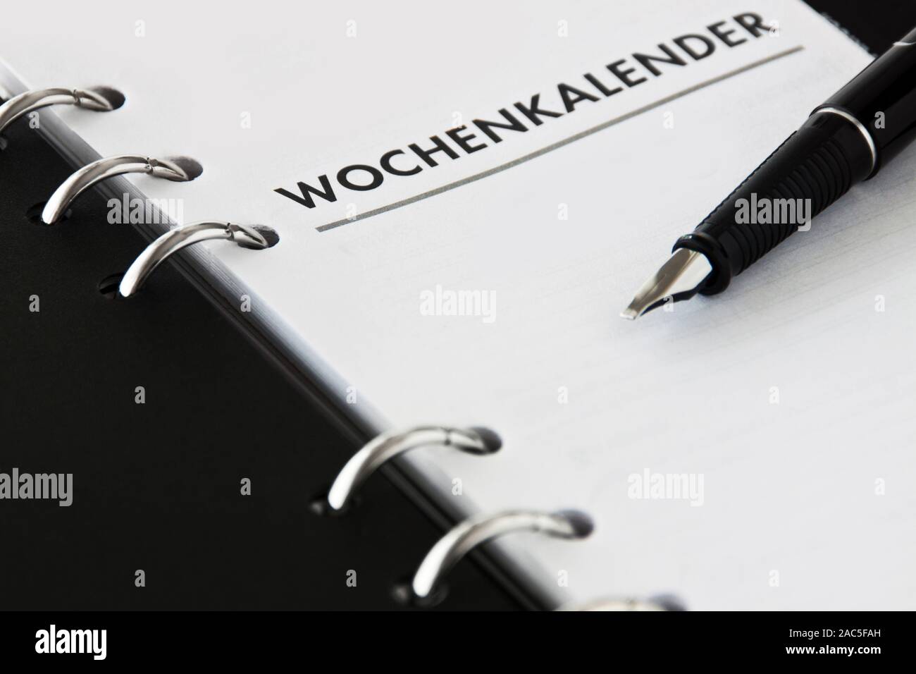 Book and pencil with German: Weekly calendar Stock Photo