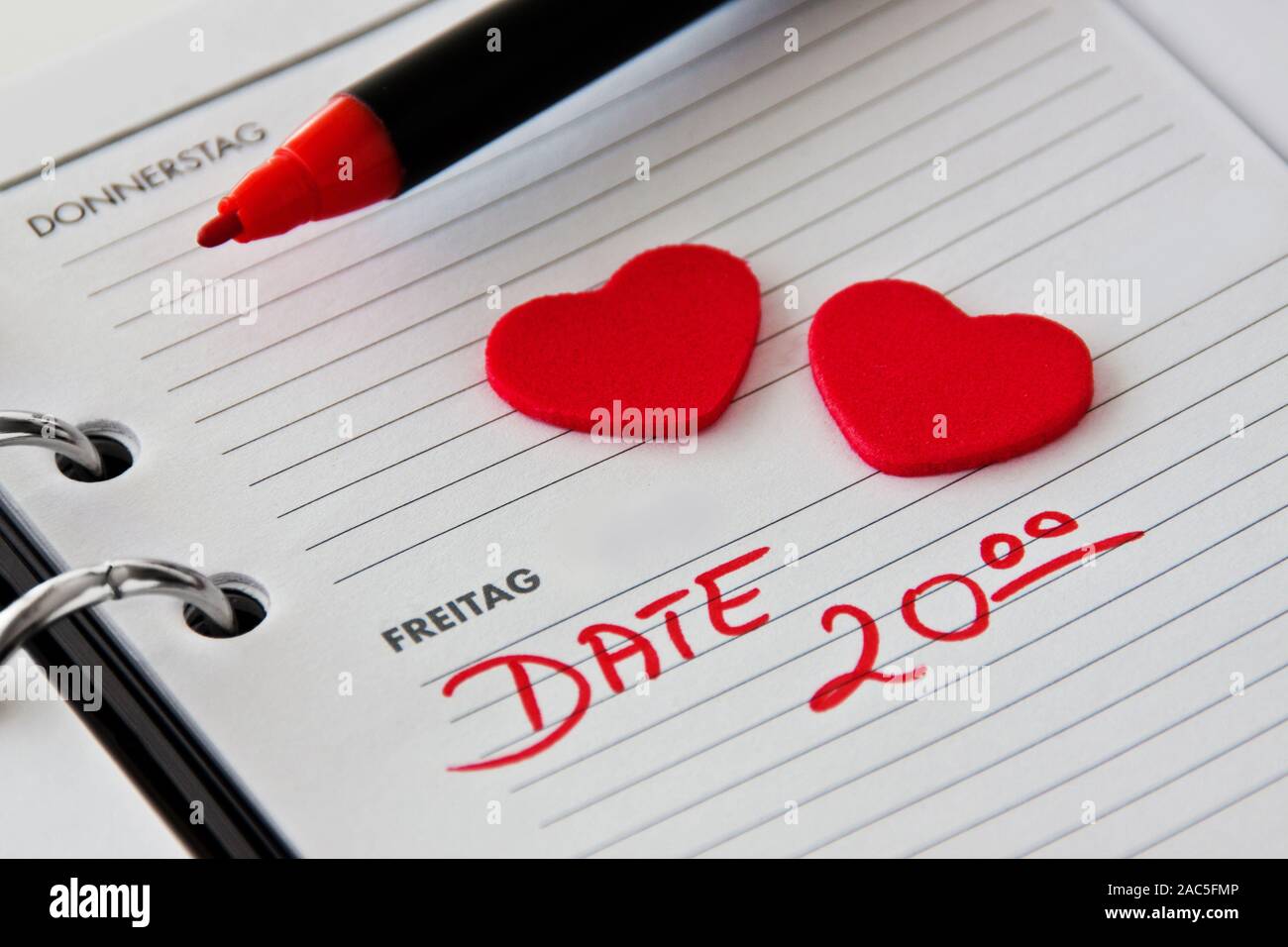 Date and two red love hearts in German calendar: Tuesday and Friday Stock Photo