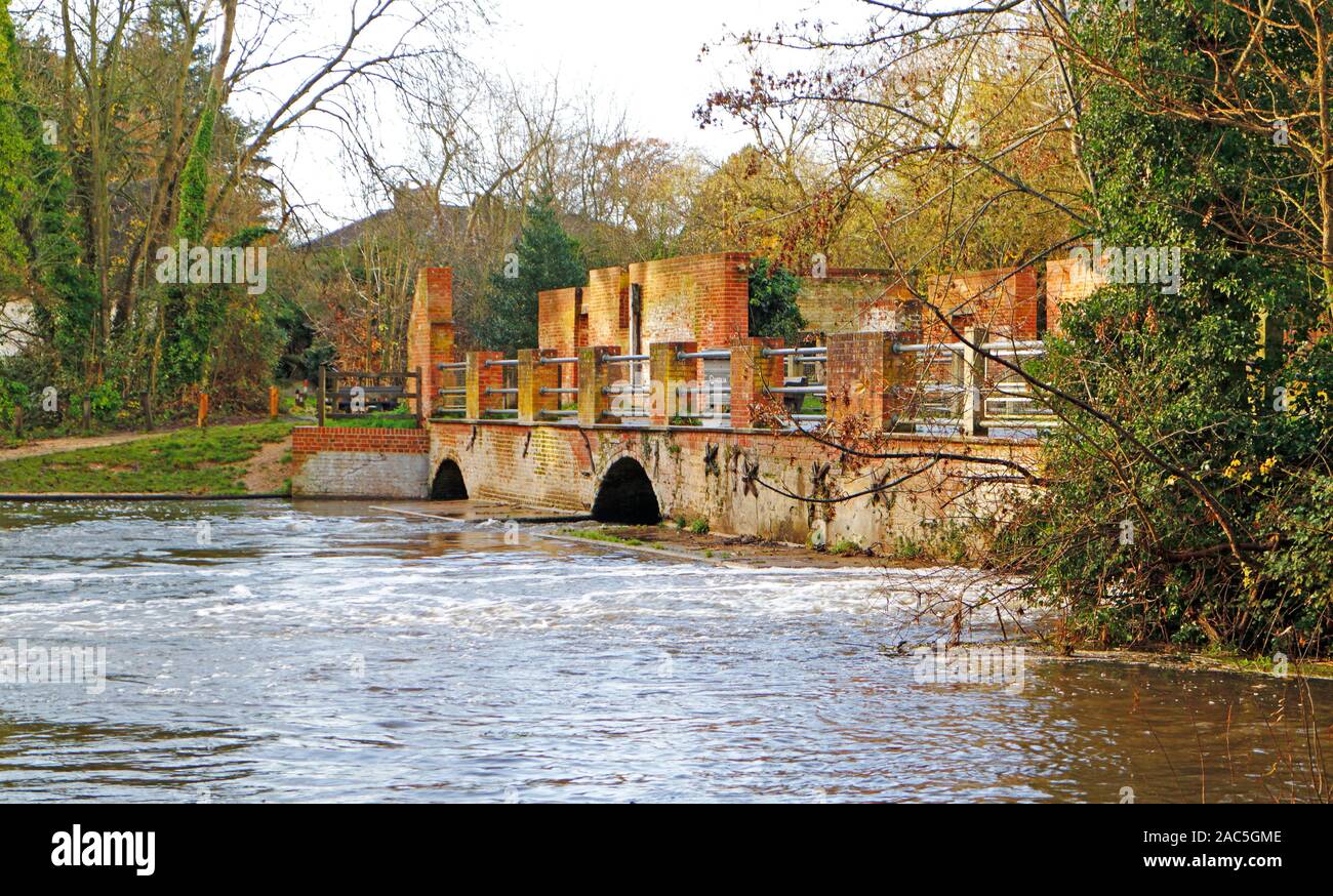 The mill pool and remains of the brick arches of the old Horstead watermill on the River Bure at Horstead, Norfolk, England, United Kingdom, Europe. Stock Photo