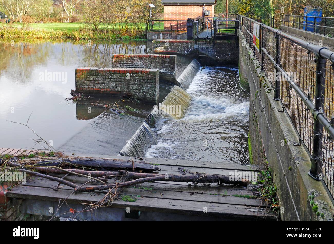 A weir and water gauging station on the River Bure by the remains of the old watermill at Horstead, Norfolk, England, United Kingdom, Europe. Stock Photo