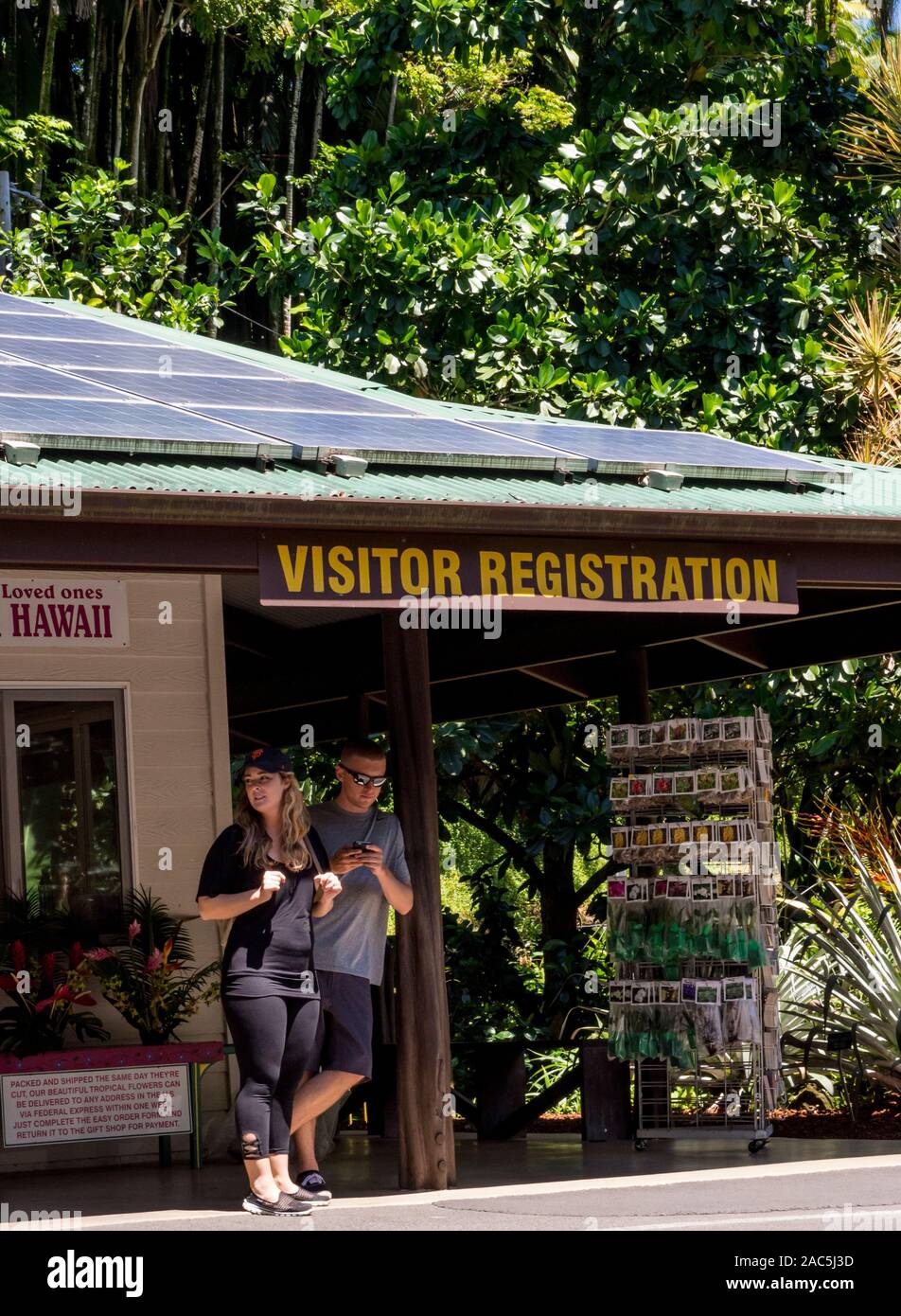 Visitors at the visitor registration sign and gift shop of the Hawaii Tropical Botanical Garden, Papa'ikou, Big Island of Hawaiʻi. Stock Photo