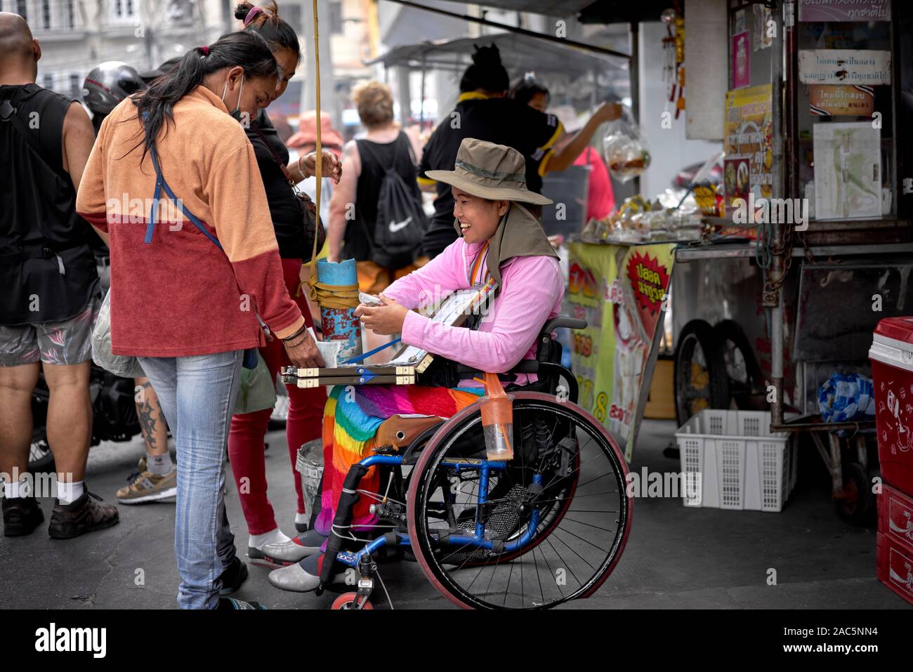 Disabled Woman In A Wheelchair Selling Lottery Tickets On A