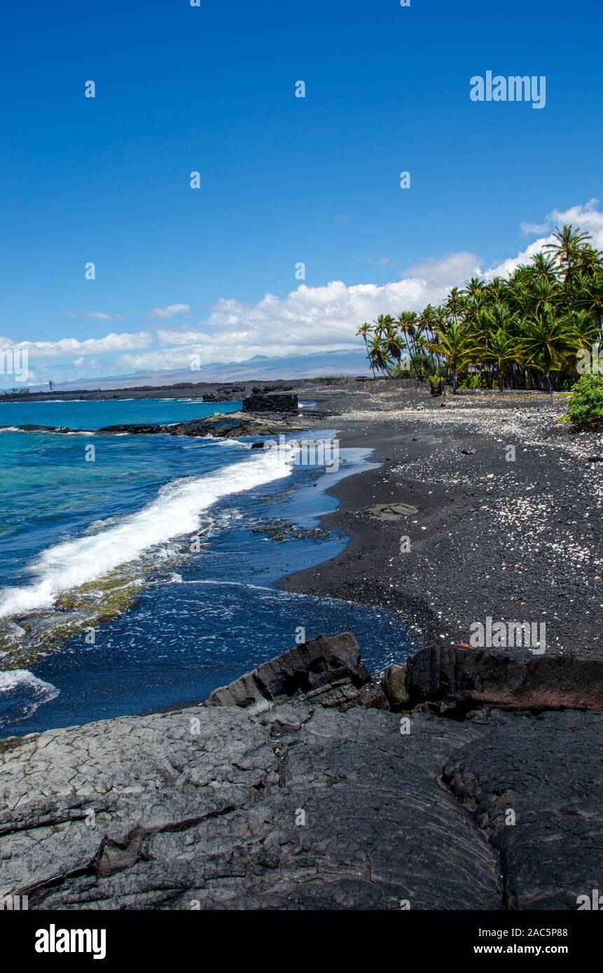 Looking north along the mostly black sand beach of Keawaiki Bay, north of Kona, Hawai'i Island; an 1859 eruption of Mauna Loa flowed into this area, w Stock Photo