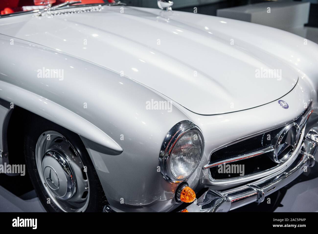 STUTTGART, GERMANY - OCTOBER 16, 2018: Mercedes Museum. Cropped photo. Red vintage automobile on a car show. Close up view on headlights Stock Photo